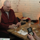 Mike Fahey of Kotaku looks down at his pink 3DS while sitting at a table.